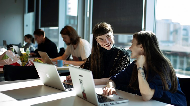 Students smiling at each other.