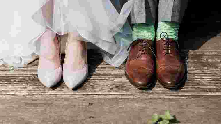 The feet of a bride and a groom.