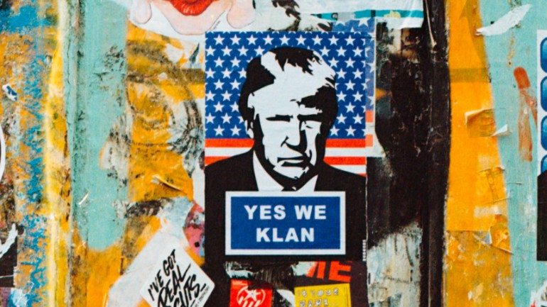 Image shows Donald Trump with the text 'yes we klan' written on a sign.