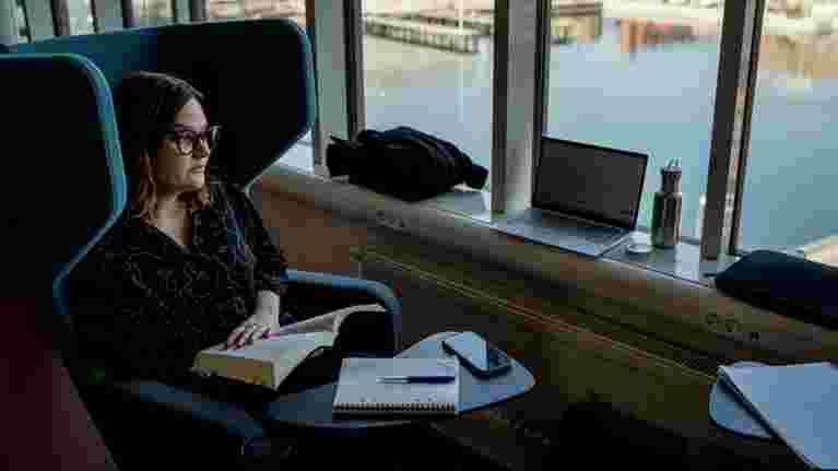 Student studying in front of window.