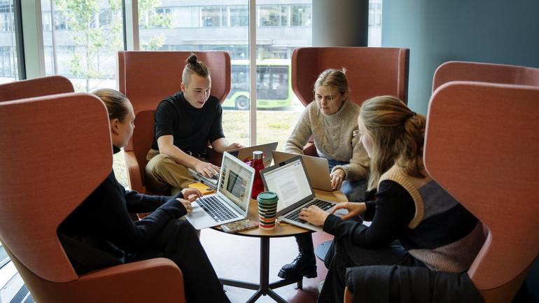 Studenter gör grupparbete runt bord