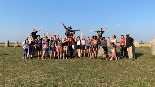 International students waving to the camera.