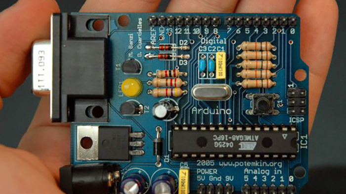 photo of the product arduino and a hand