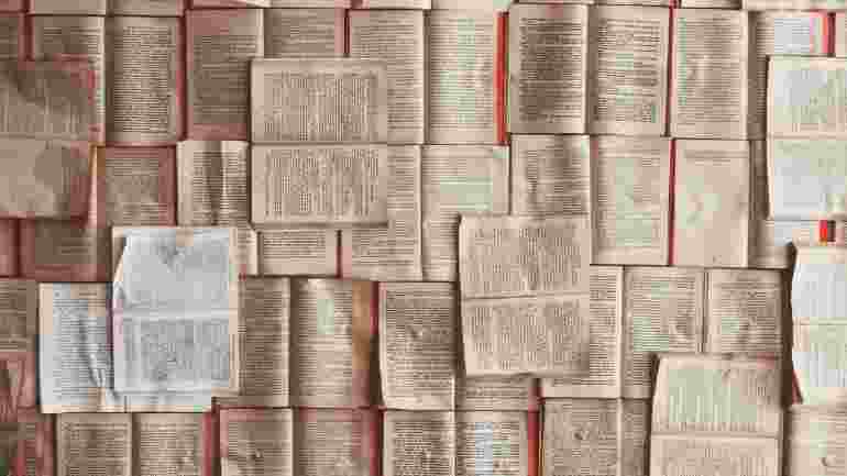 Photo shows lots of books with open pages laid out side by side