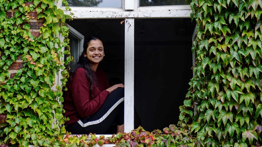 Tenant sitting in window looking into the camera.