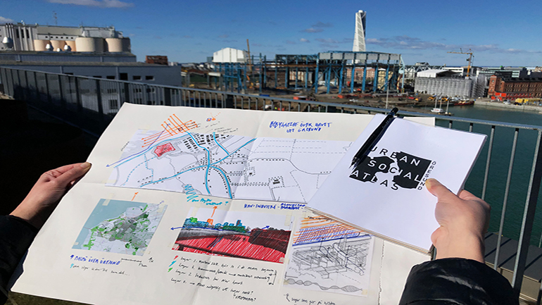 A map with a city landscape as background. 